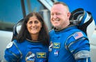 NASA astronauts Suni Williams, left, and Butch Wilmore, wearing Boeing spacesuits, depart the Neil A. Armstrong Operations and Checkout Building at Kennedy Space Center in Florida on June 5, 2024. 