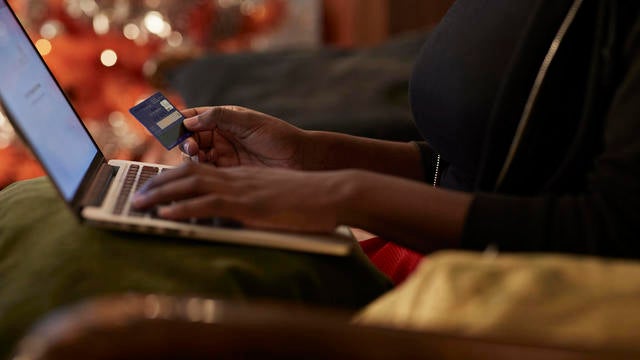 Young woman ordering Christmas gifts online 