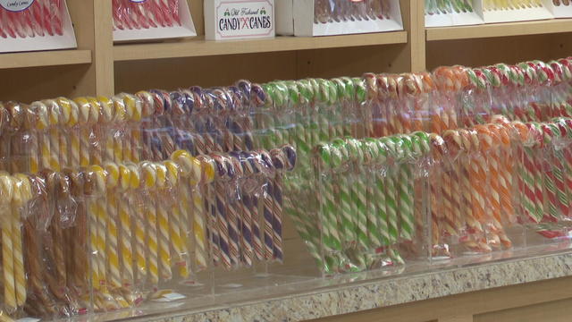 Rows of different colored candy canes line a shelf at Giambri's candy store 