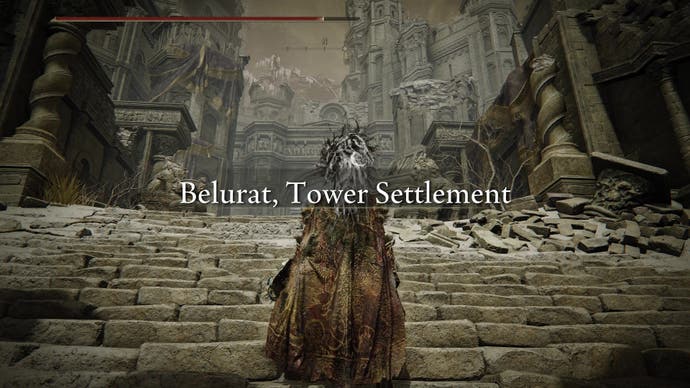 A warrior approaches Belurat, Tower Settlement in Elden Ring's Shadow of the Erdtree expansion.