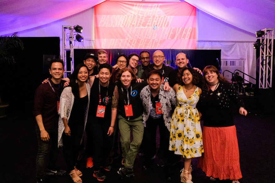 Automatticians (folks who work at Automattic) standing proud and happy at an industry event.