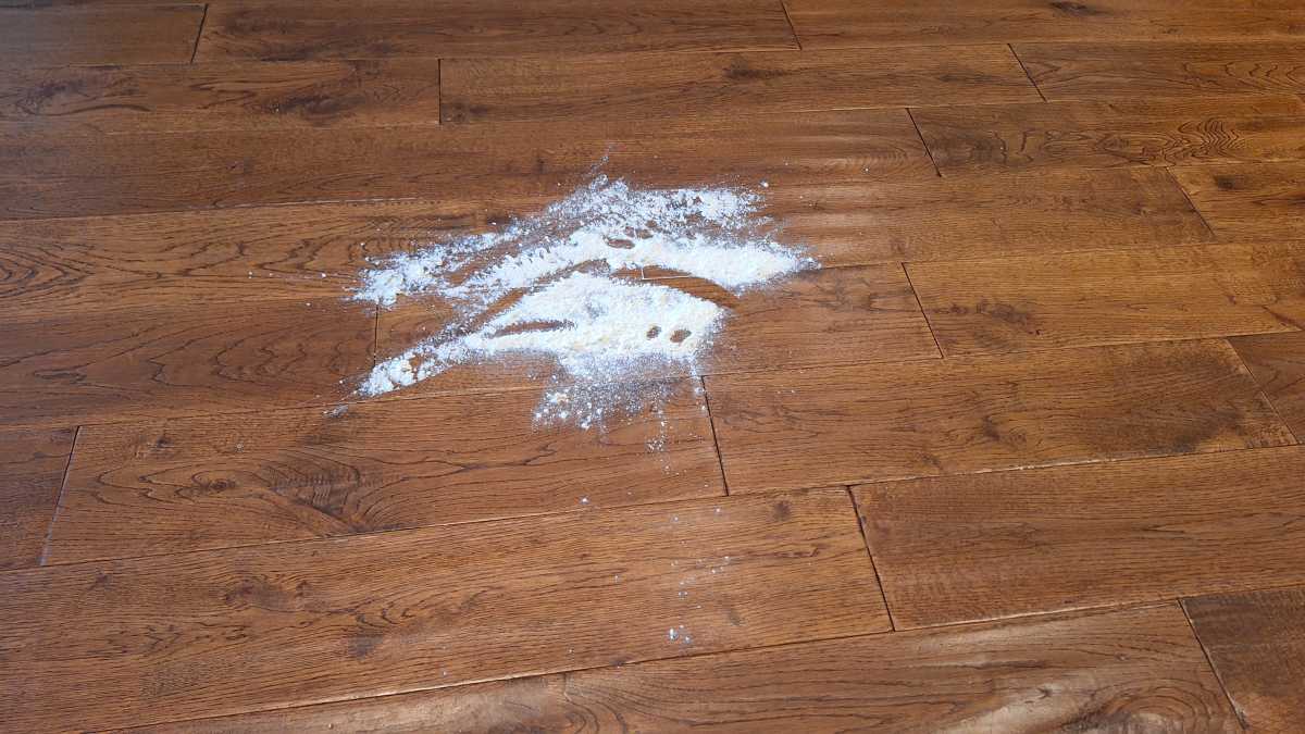 A view of the flour on the floor before the Gtech Orca flour test.