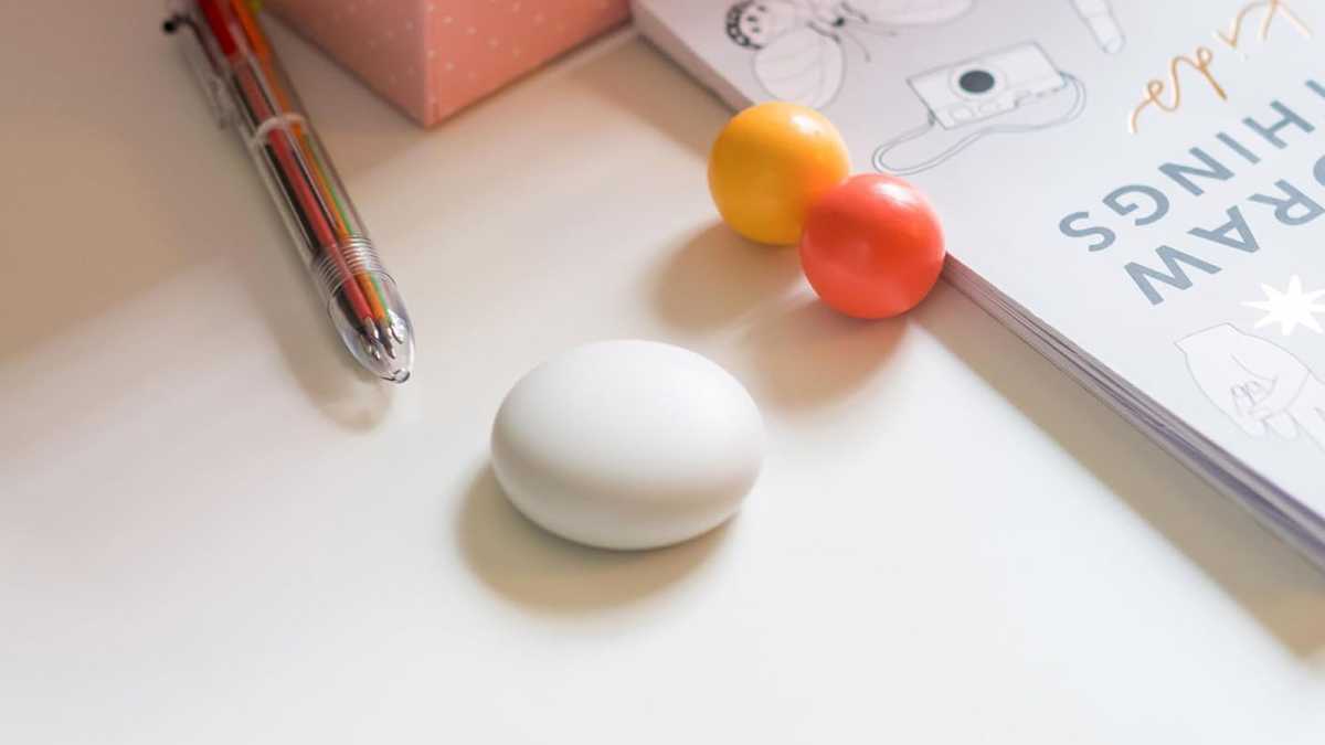 Pebble-like sensor, on a desk with pens and paper