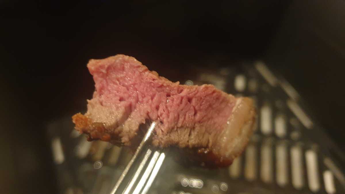 Side section of medium-rare steak cooked in the Cooked steak in the Dreo ChefMaker Combi Cooker  