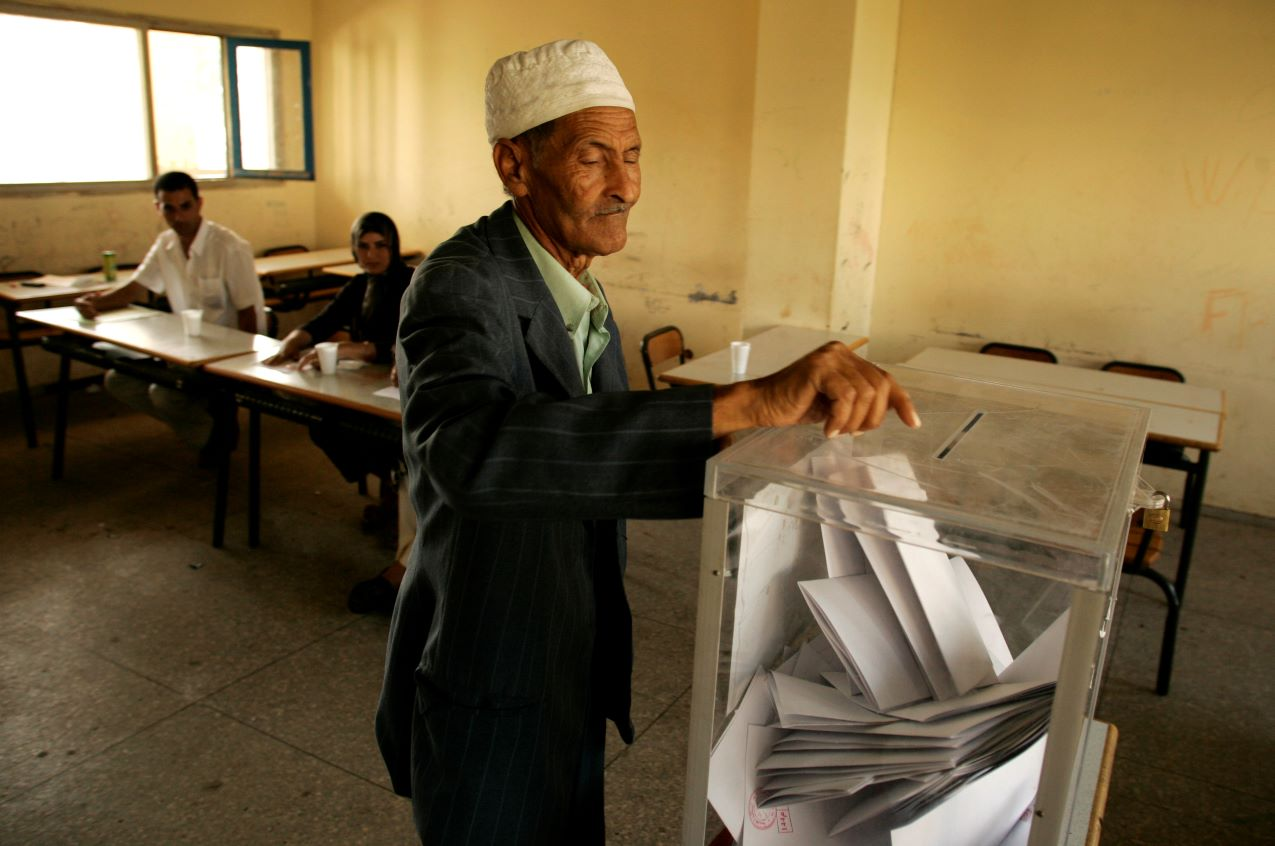 An old man casts his vote into a clear voting box at a polling station during the general elections in Sale, Morocco on September 7, 2007. REUTERS/Rafael Marchante