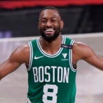 Boston Celtics guard Kemba Walker (8) laughs as he takes the ball up court during the second quarter of Game 2 of an NBA basketball first-round playoff series against the Brooklyn Nets, Tuesday, May 25, 2021, in New York.