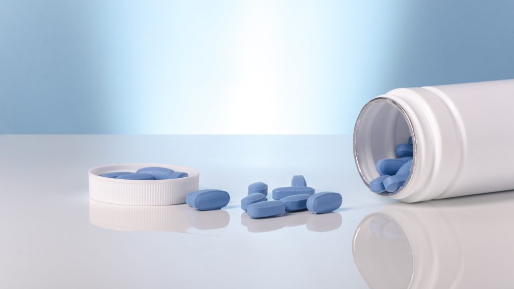 viagra blue tablets over white and blue background.