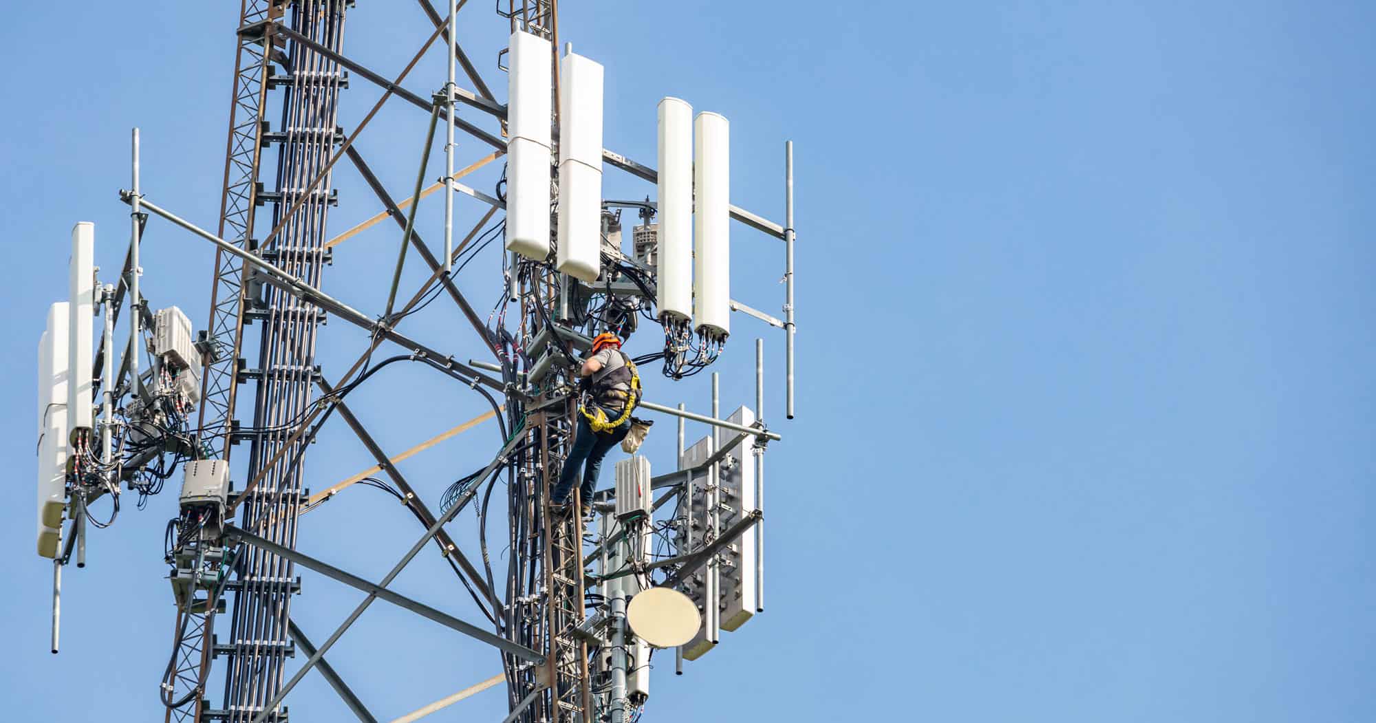 utility worker on communication tower