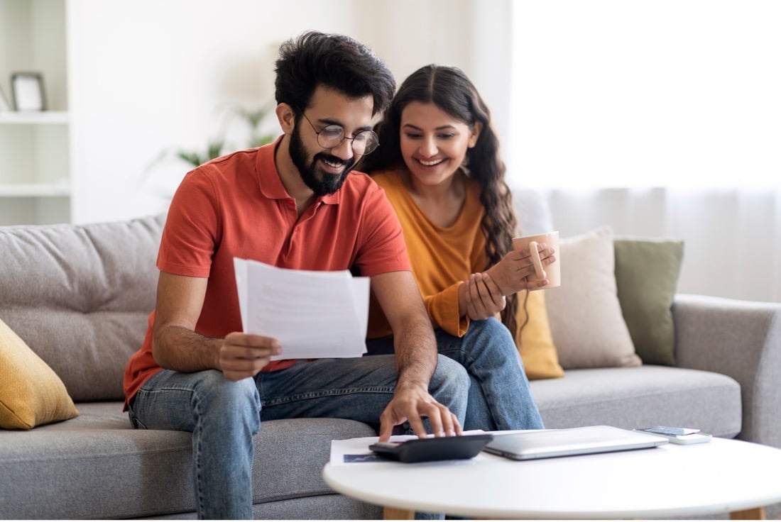 A young couple is calculating the ROI of installing solar panels.