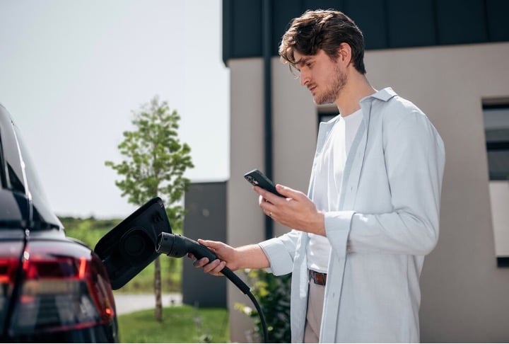 A man is charging his EV using EVBox Livo.