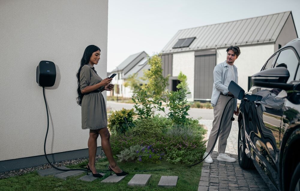 A couple using their EVBox Livo home charging station (Level 2).