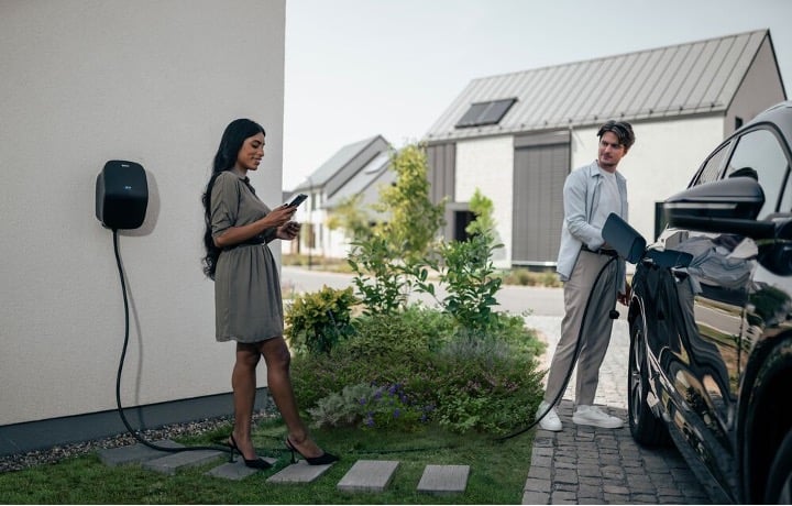 A couple are charging their EV using EVBox Livo.