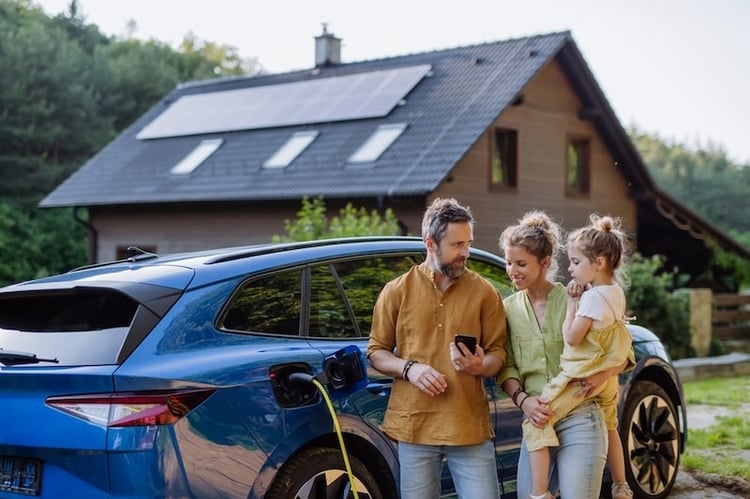 A family are waiting for their EV to be charged.