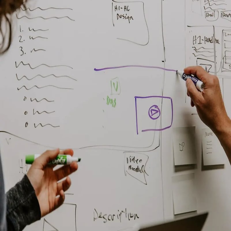 Man writing on white board