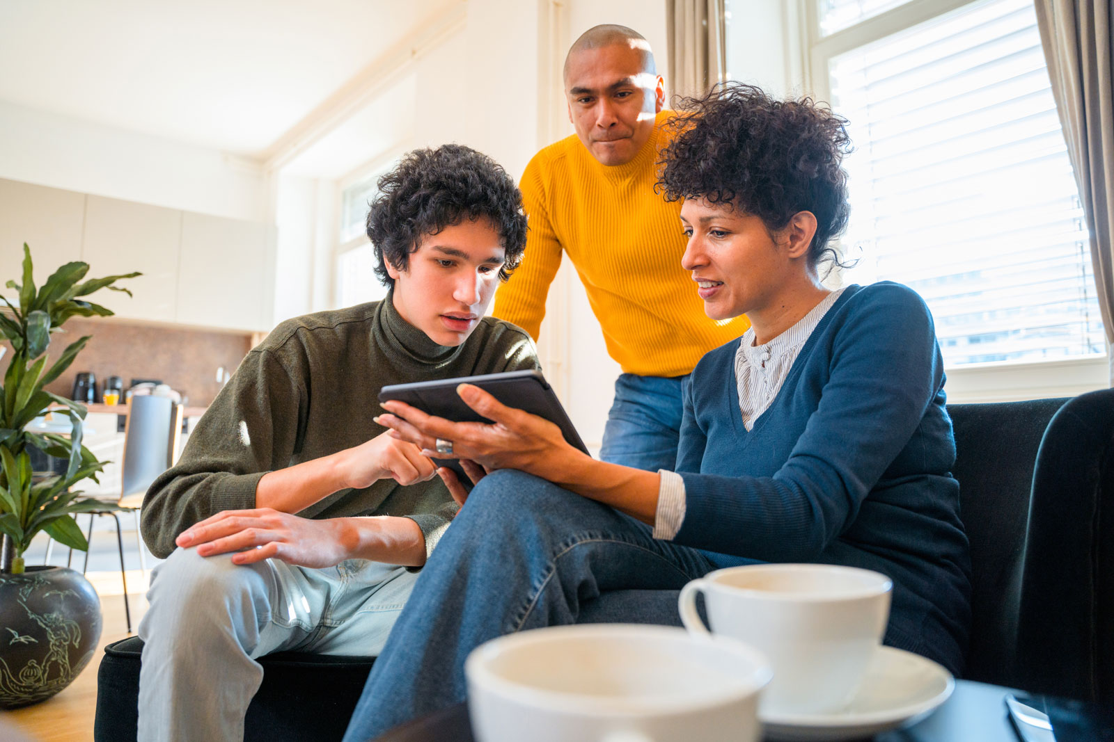 a family looking at a tablet