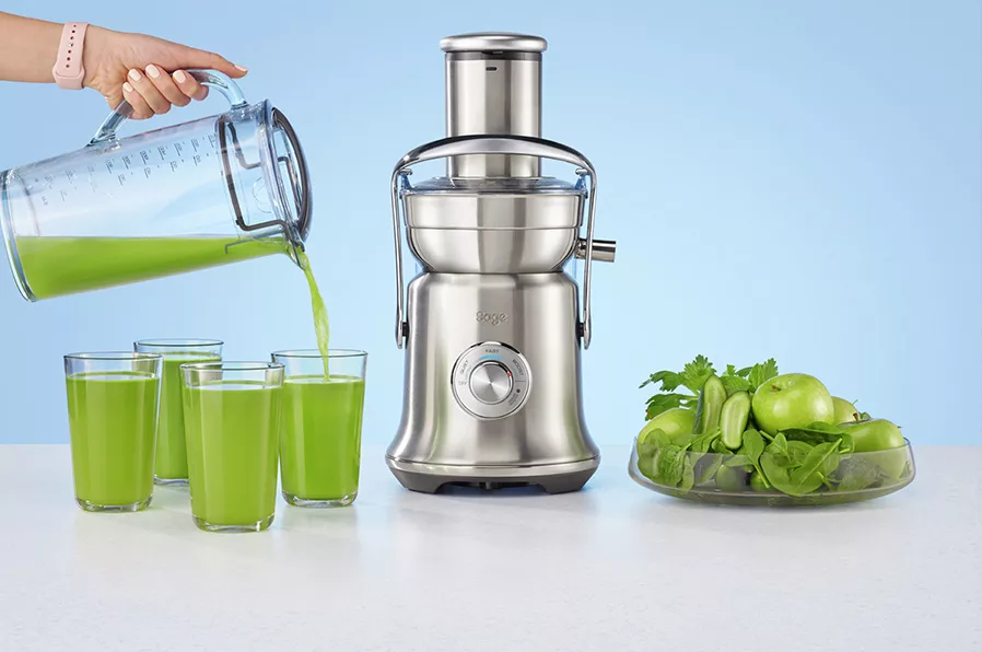 sage juicer on bench with colourful fruits and vegetables 