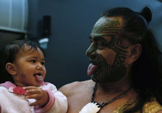 New Zealand's ethnic Maori Metini Mitai Ngatai and his son Niwareka joke prior to the official opening of the book fair in Frank