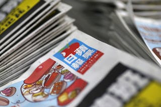 A copy of the Apple Daily newspaper, published by Next Media, are seen at the company's printing facility in Hong Kong, China