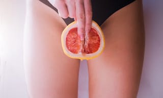 A woman is holding a grapefruit by her panties. Concept masturbation