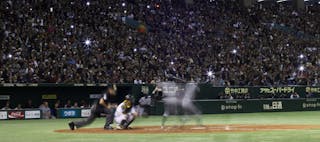 Spectators take pictures of Seattle Mariners' Ichiro Suzuki in the batter's box during the sixth inning of their second baseball