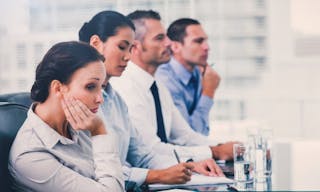 Businesswoman in bright office getting bored while attending presentation