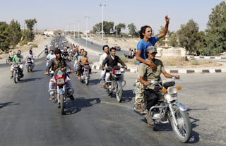 Residents of Tabqa city and Islamic State militants tour the streets in celebration after Islamic State militants took over Tabq