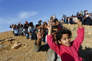 Turkish Kurds shout slogans is support of Kurdish fighters in Kobani as they gather on the hill near the Mursitpinar border cros