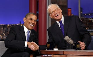 Seated with talk show host David Letterman, U.S. President Barack Obama makes an appearance on the "Late Show with David Letterm