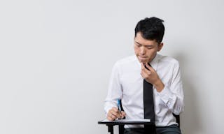 Chinese male student or business man taking an exam test