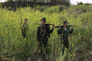 Rebel soldiers of Myanmar National Democratic Alliance Army (MNDAA) patrol near a military base in Kokang region