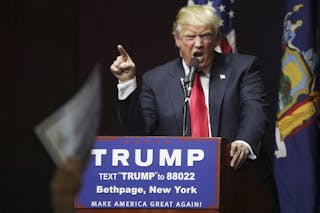 U.S. Republican presidential candidate Donald Trump speaks on stage during campaign event at Grumman Studios in Bethpage, New Yo