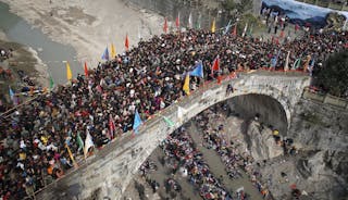 People crowd onto a bridge during the annual Caiqiaohui event in Mianyang