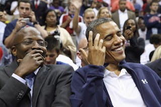 U.S. President Obama shares a laugh with former assistant Love as he arrives to attend an Olympic basketball exhibition game bet