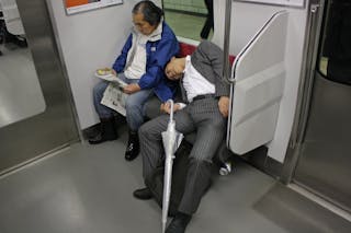 Japanese Salaryman dead asleep on the Tokyo subway. I know it's jerky of me to have taken this picture and posted it here, but..