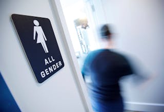 A bathroom sign welcomes both genders at the Cacao Cinnamon coffee shop in Durham, North Carolina