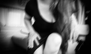 Portrait of woman blurred in black dress,emotions concept in car black and white