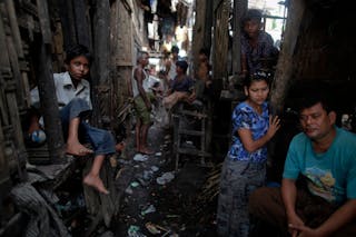 Myanmar Rohingya people pass the time at their slum near the sea in the town of Sittwe