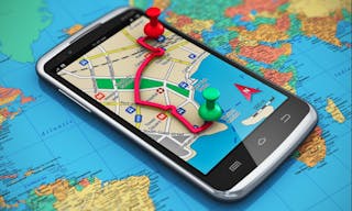 Mobile GPS navigation, travel and tourism concept: macro view of modern black glossy touchscreen smartphone with GPS navigation 