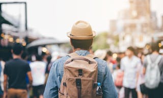 Young male traveler traveling backpacker walking street market in among the many people., filler Vintage Tone and Selective Soft