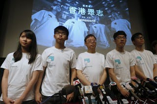 Committee members of Demosisto Chow, Wong, Ip, Chairman Law and Lai pose in front of a backdrop during the launching ceremony of