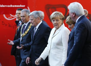 German officials walk to attend a church service marking the 25th anniversary of the reunification of Germany at Paulskirche Chu