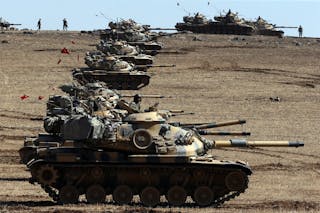 Turkish army tanks take up position on the Turkish-Syrian border near the southeastern town of Suruc in Sanliurfa province