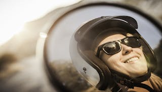 Woman wearing motorbike helmet and sunglasses