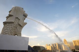 Water spouts out of the mouth of the Merlion statue as engineers test repairs made to it in Singapore