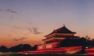 Tiananmen Gate of the Forbidden City at sunset, in Beijing, China, with placards saying "Long Live the People's Republic of Chin