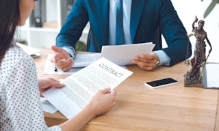 Cropped shot of lawyer holding papers and client reading contract in office — Photo by AndrewLozovyi