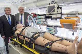 German Foreign Minister Steinmeier and Health Minister Hermann Groehe stand in isolation unit of new Medevac plane in Berlin