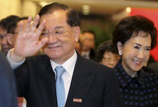 連戰 Honorary Chairman of the Kuomintang Lien Chan waves as he arrives at a ceremony with his wife Lien Fang-yu at the Peking Univ