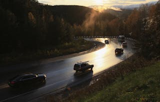 Vehicles drives along the M54 Yenisei Federal Highway during sunset outside Russia's Siberian city of Krasnoyarsk