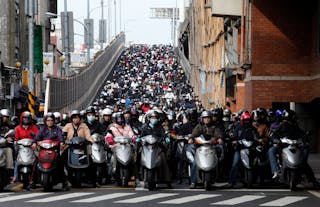 Motorists ride to work on a bridge during rush hour in Taipei, Taiwan